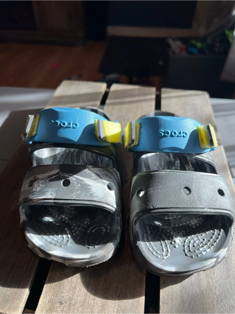 CROCS Kids Black Sandals with Blue and Yellow Accents
